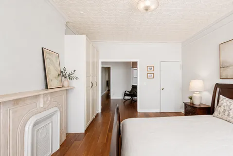 a bedroom with a bed and a chandelier