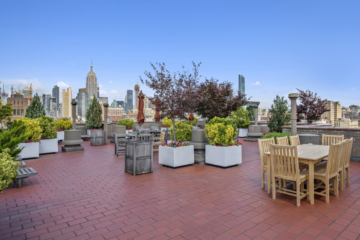 77 7th Avenue, Unit 12P Manhattan, NY 10011 - Photo 13 of 15 a view of a patio with chairs and potted plants