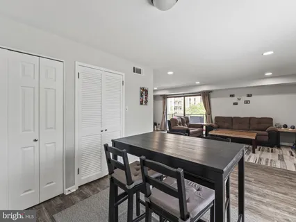 a dining room with furniture and wooden floor