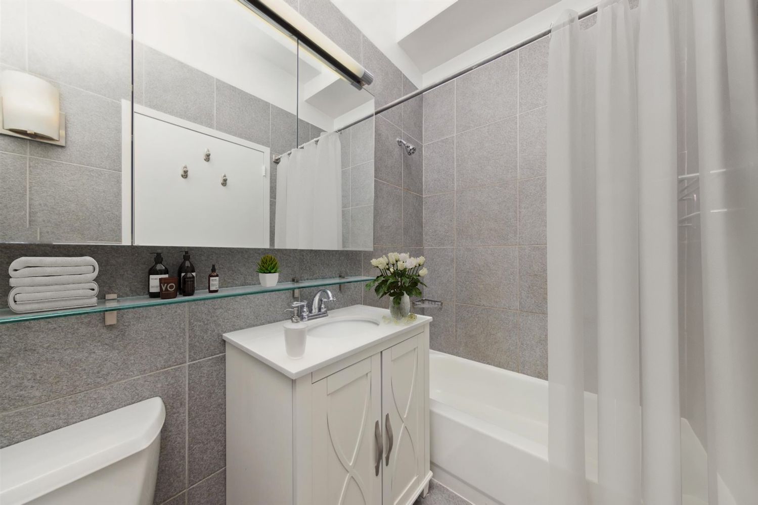 80 John Street, Unit 9C Manhattan, NY 10038 - Photo 8 of 9 a bathroom with a sink a toilet and a bathtub