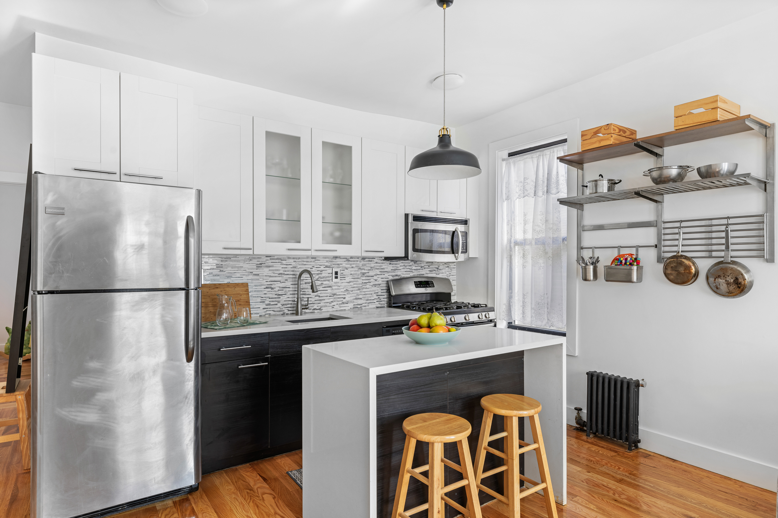 839 East 19th Street, Unit 4D Brooklyn, NY 11230 - Photo 2 of 10 a kitchen with stainless steel appliances granite countertop a refrigerator a stove and a sink with wooden floor