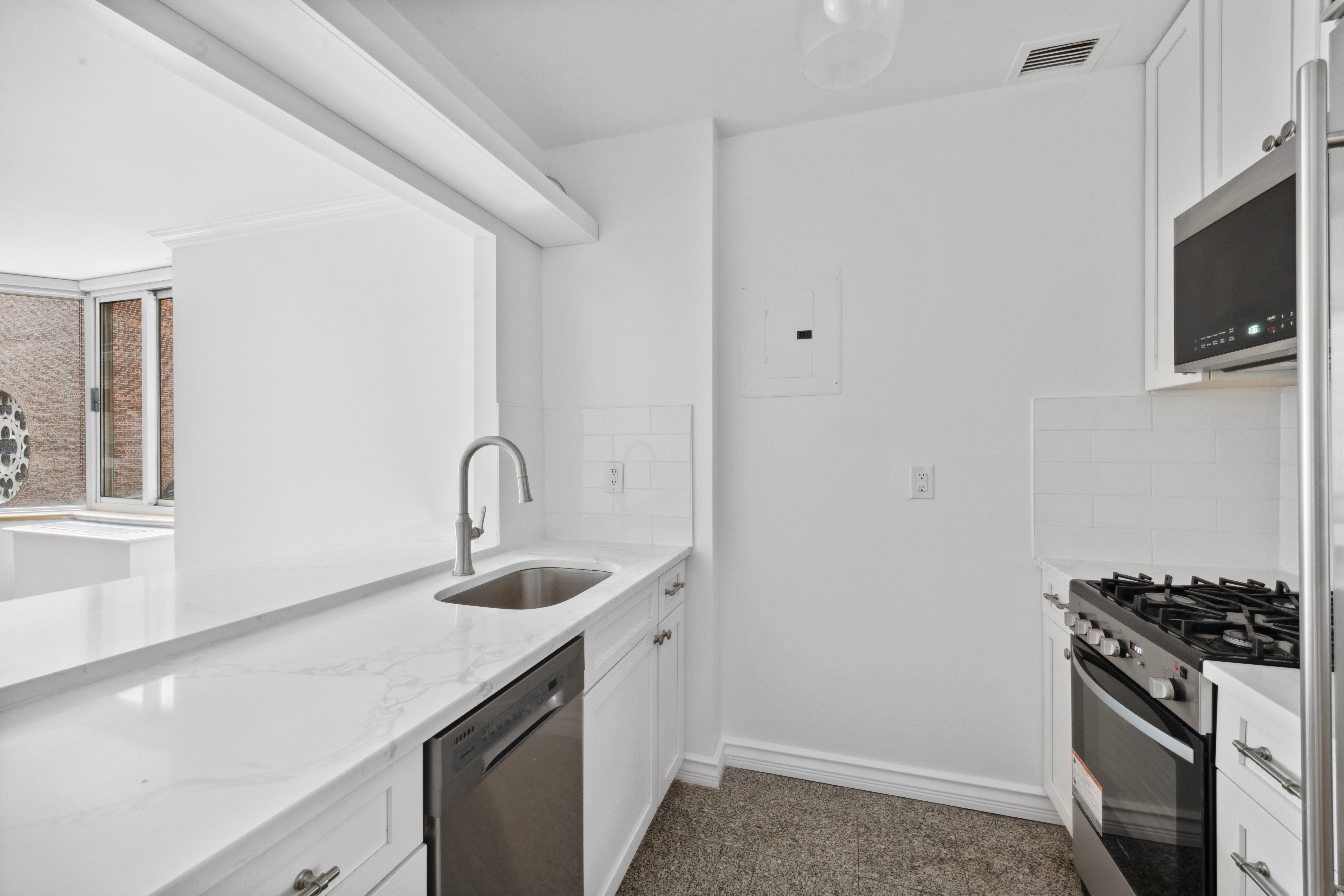 201 West 72nd Street, Unit 3I Manhattan, NY 10023 - Photo 6 of 13 a kitchen with sink a microwave and stove