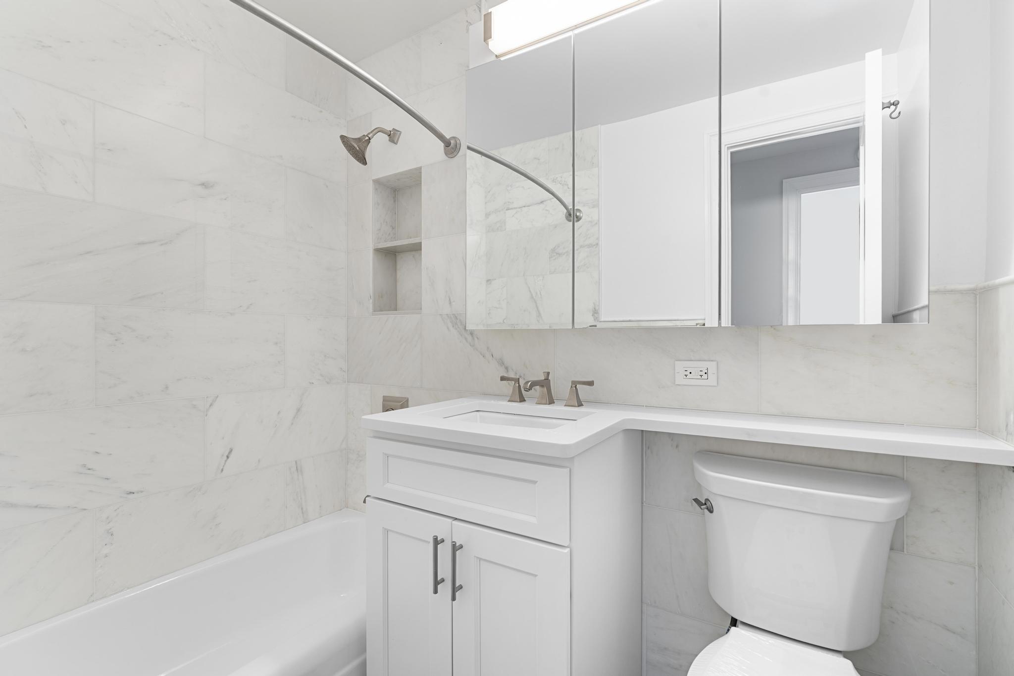 155 West 68th Street, Unit 1027 Manhattan, NY 10023 - Photo 8 of 8 a bathroom with a sink a toilet and shower