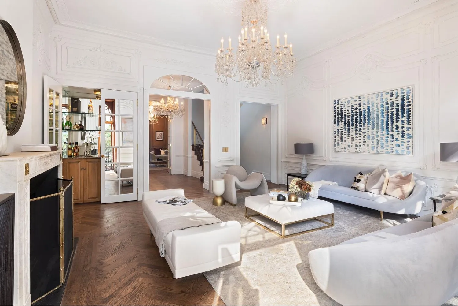 a living room with furniture and a chandelier