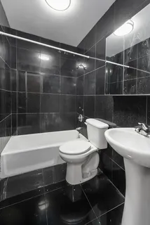 a bathroom with a sink a toilet and bathtub