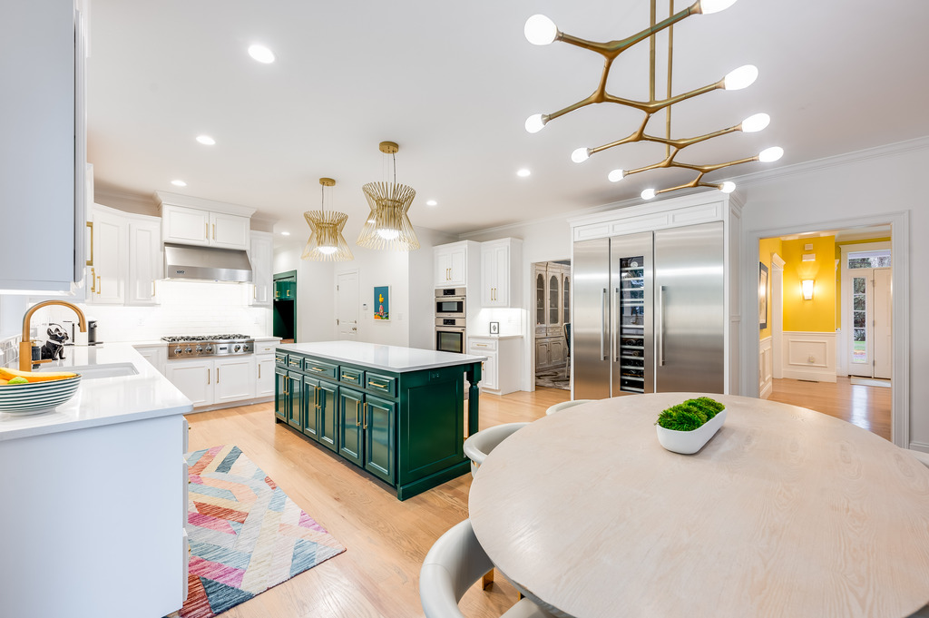 45 Washburn Avenue Needham, MA 02492 - Photo 8 of 23 a kitchen with stainless steel appliances granite countertop a sink a stove and a refrigerator