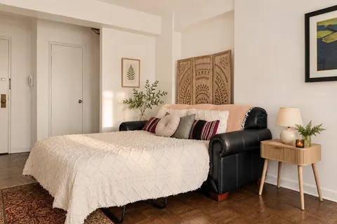 a bedroom with a bed and a chair