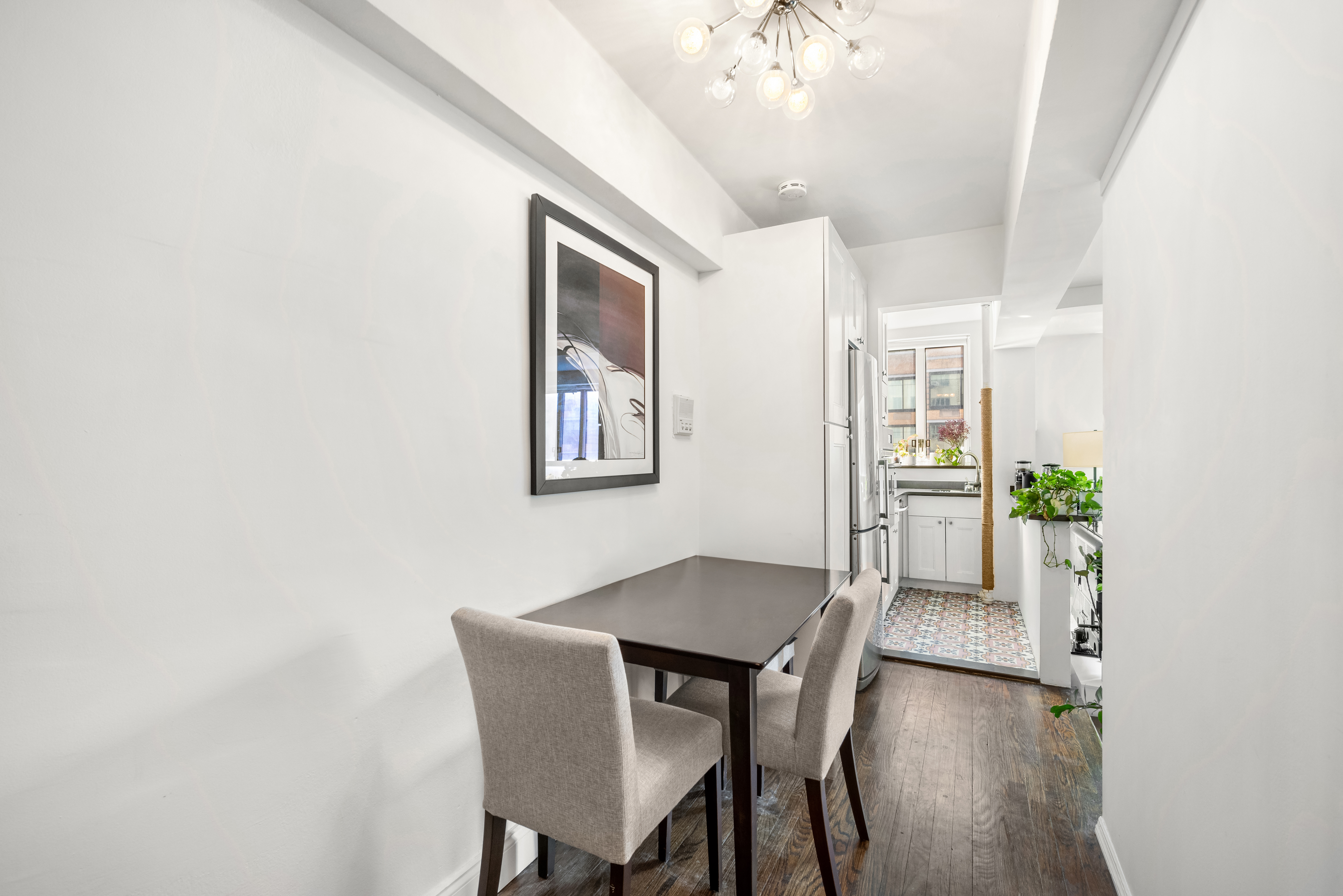 200 West 20th Street, Unit 905 Manhattan, NY 10011 - Photo 6 of 17 a view of a dining room with furniture and wooden floor