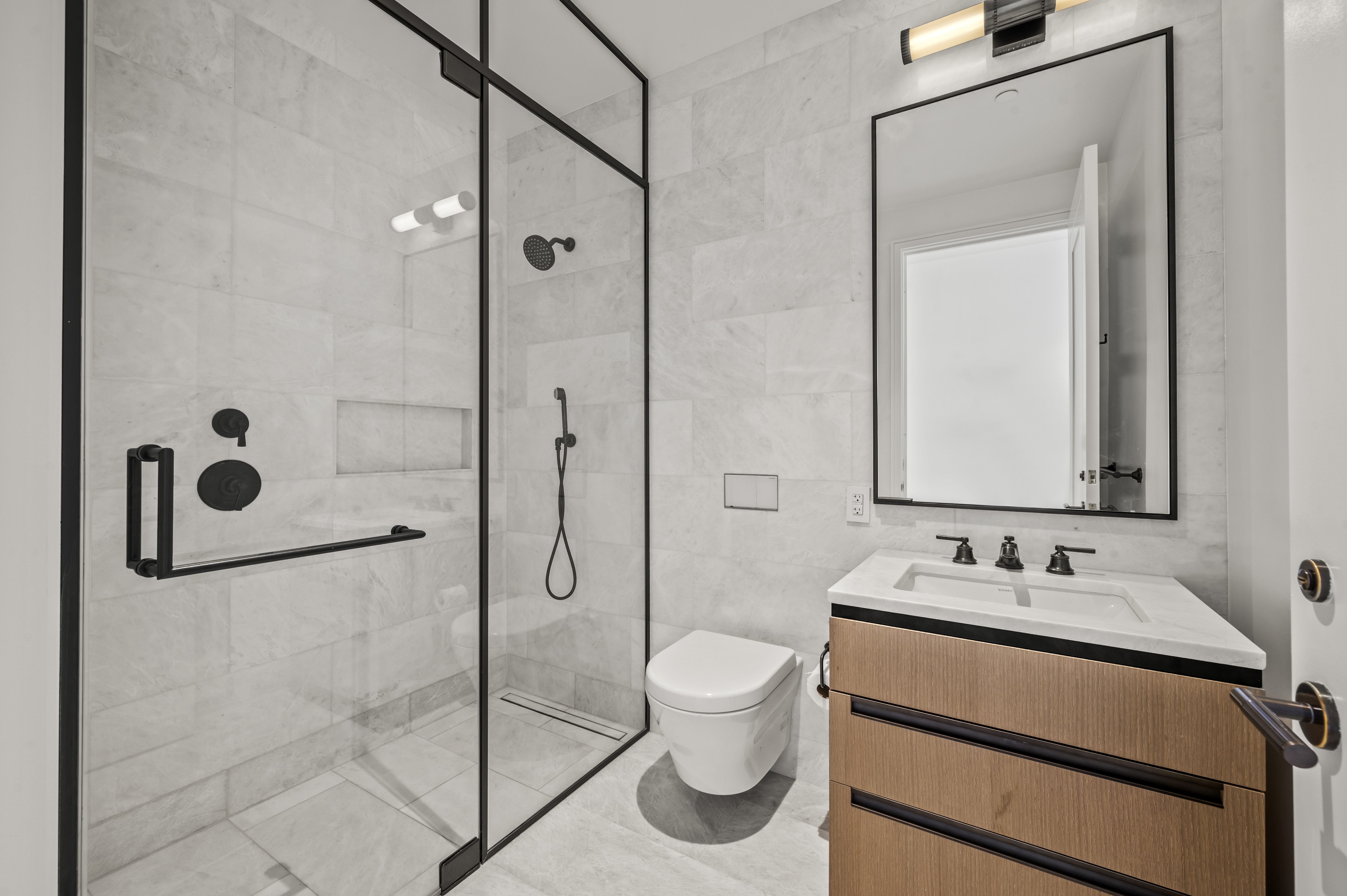515 West 18th Street, Unit 1401 Manhattan, NY 10011 - Photo 7 of 12 a bathroom with a sink and a mirror
