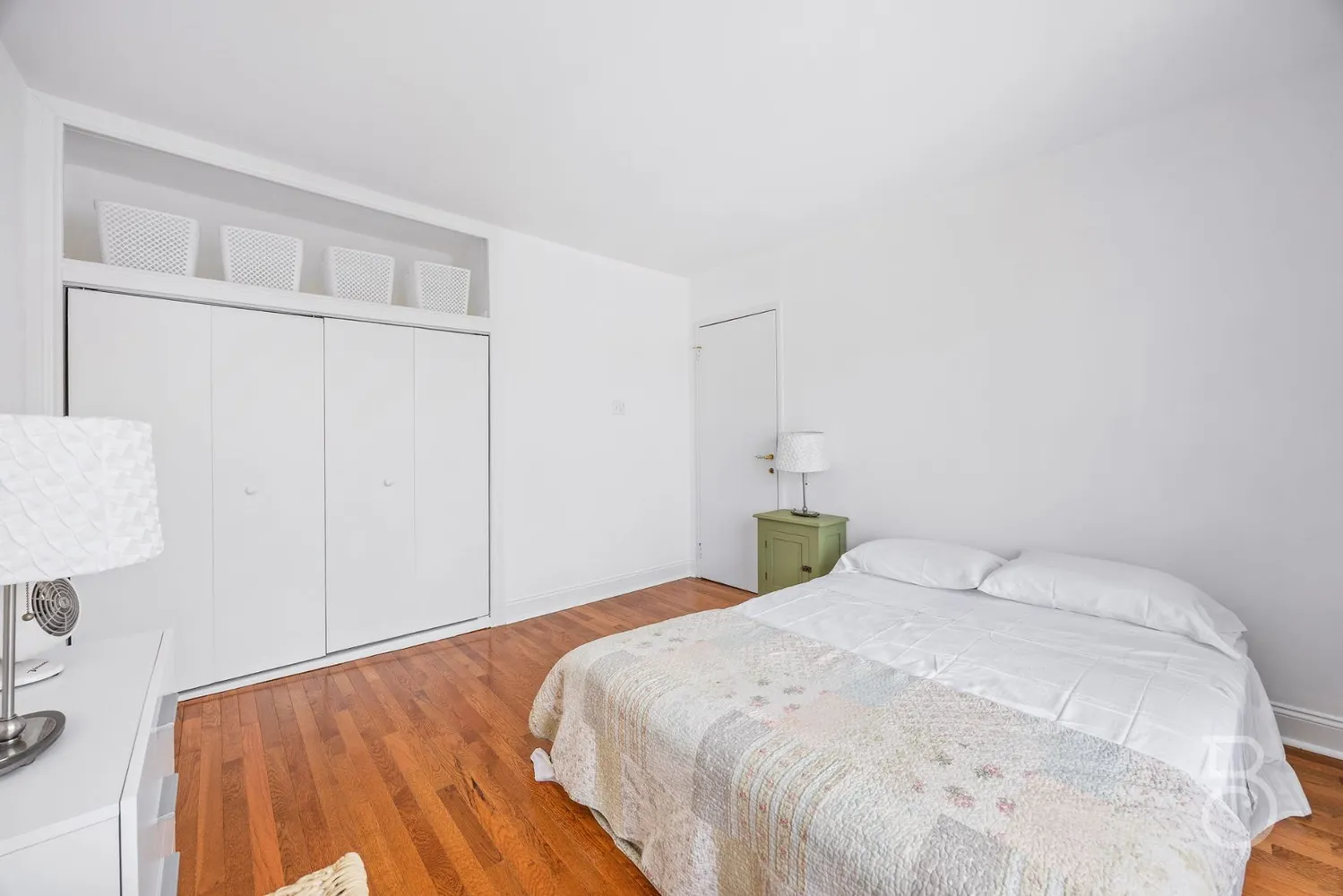 a bedroom with a bed and a night stand