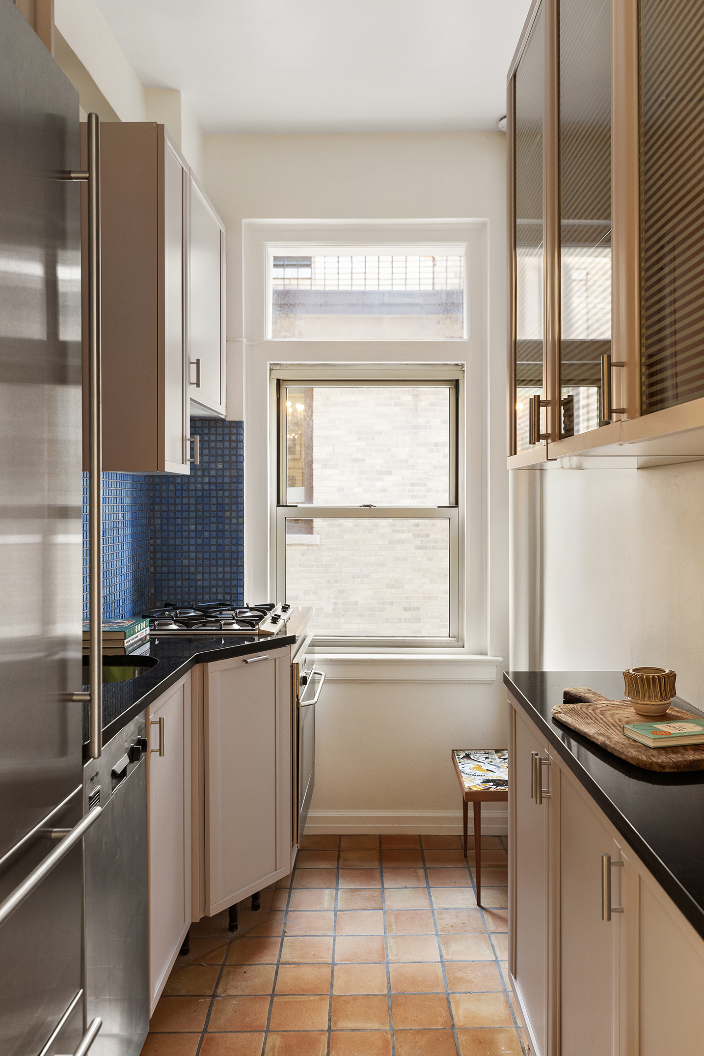 44 Gramercy Park North, Unit 15D Manhattan, NY 10010 - Photo 8 of 11 a kitchen with granite countertop a sink stove and cabinets