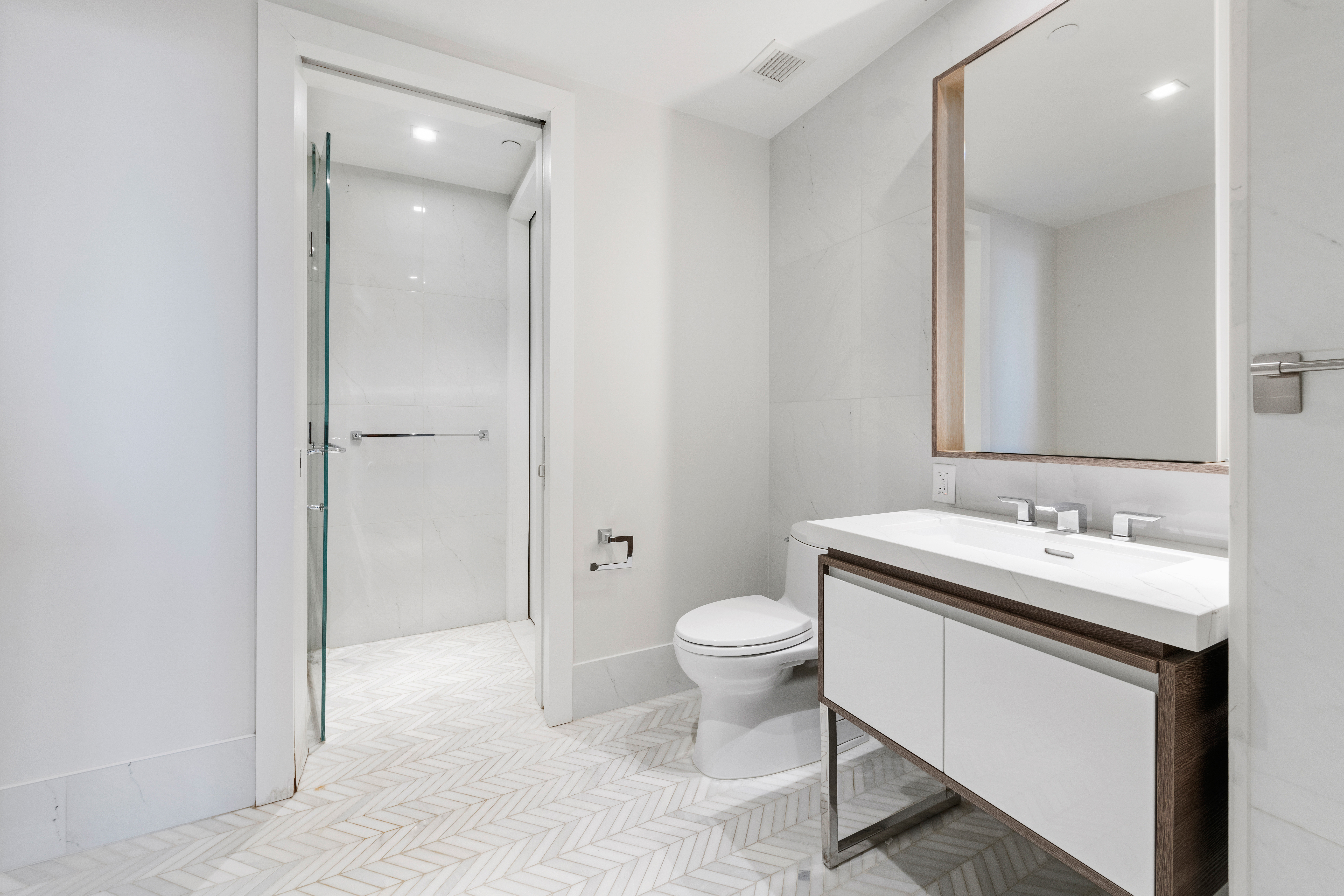 505-513 West 43rd Street, Unit 10B Manhattan, NY 10036 - Photo 12 of 22 a bathroom with a sink toilet a mirror and shower