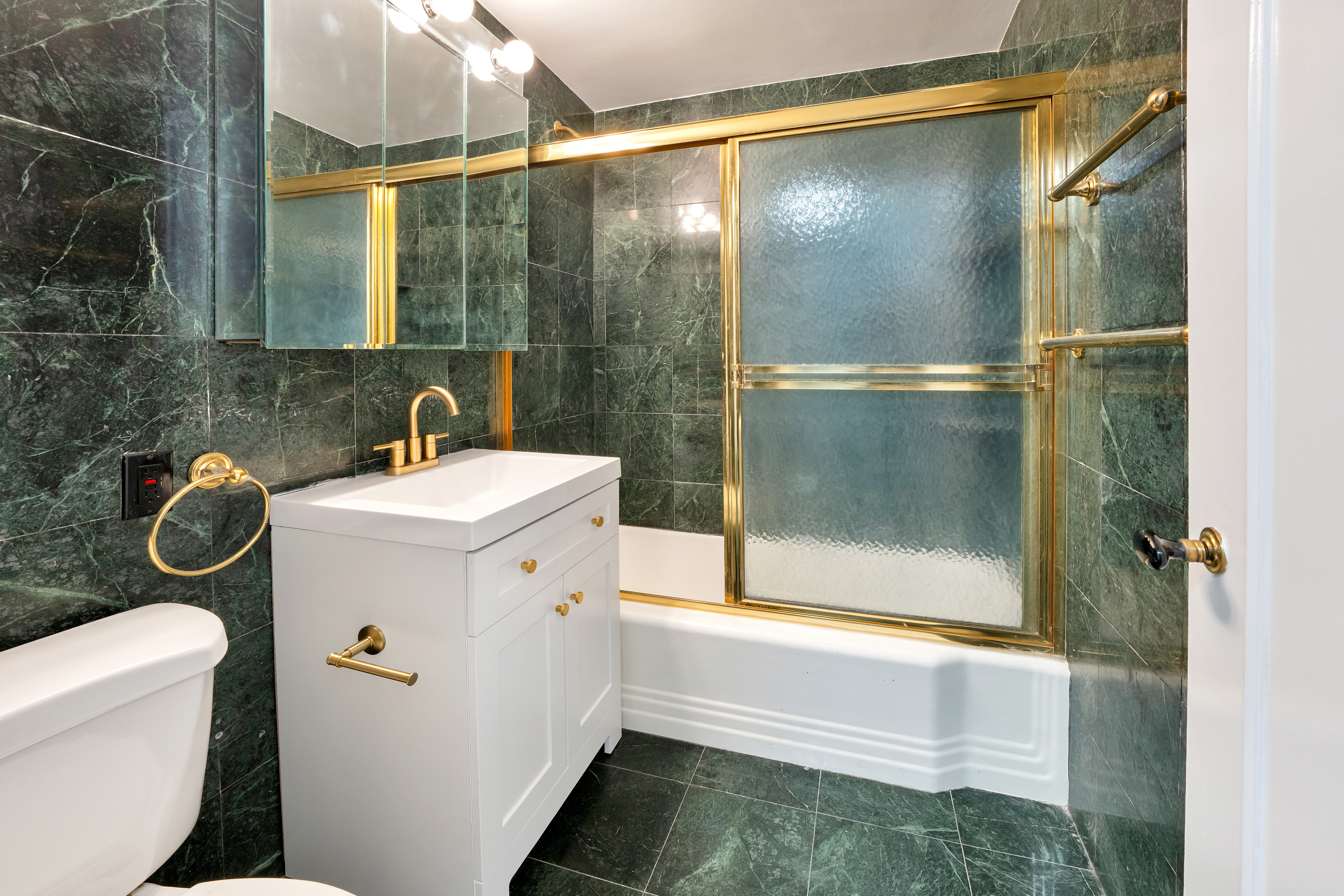 36 Sutton Place South, Unit 8E Manhattan, NY 10022 - Photo 4 of 7 a bathroom with a sink toilet and shower