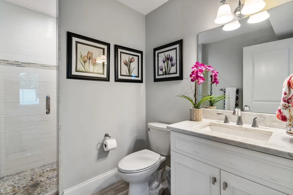 a utility room with stainless steel appliances wooden floor and window