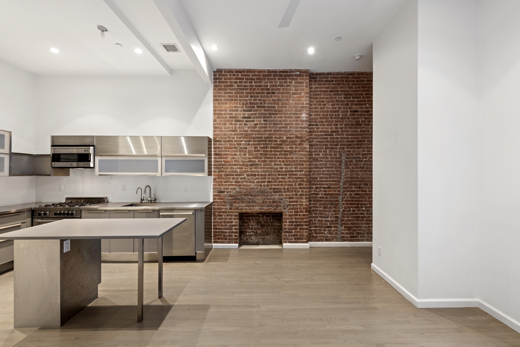 220 West 79th Street, Unit PARLOUR Manhattan, NY 10024 - Photo 2 of 9 a room with a wooden floor and a fireplace