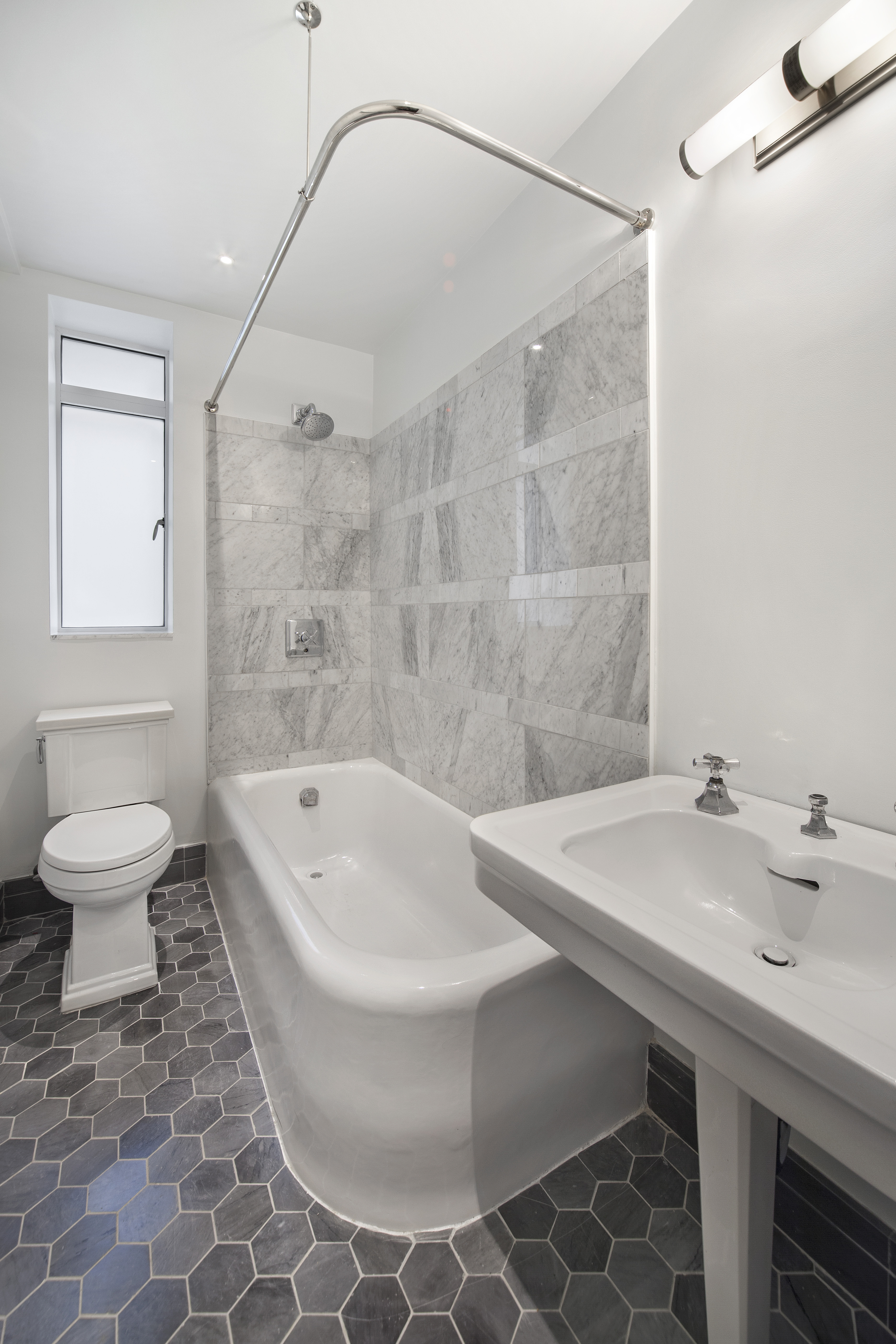 25 Central Park West, Unit 4U Manhattan, NY 10023 - Photo 7 of 8 a bathroom with a sink a toilet and a mirror