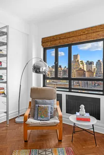 a living room with furniture a rug and outdoor view