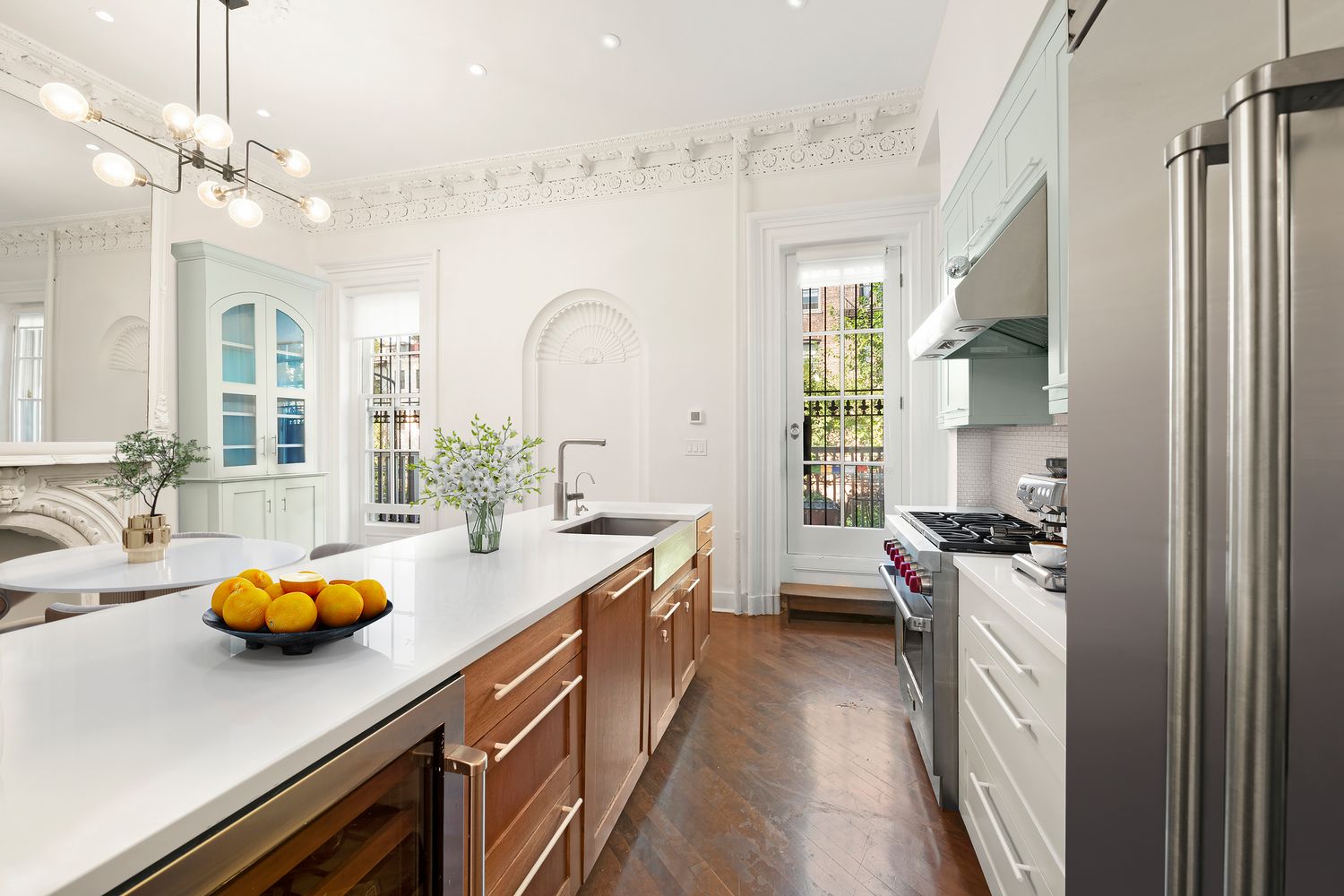 a kitchen with sink a stove and cabinets