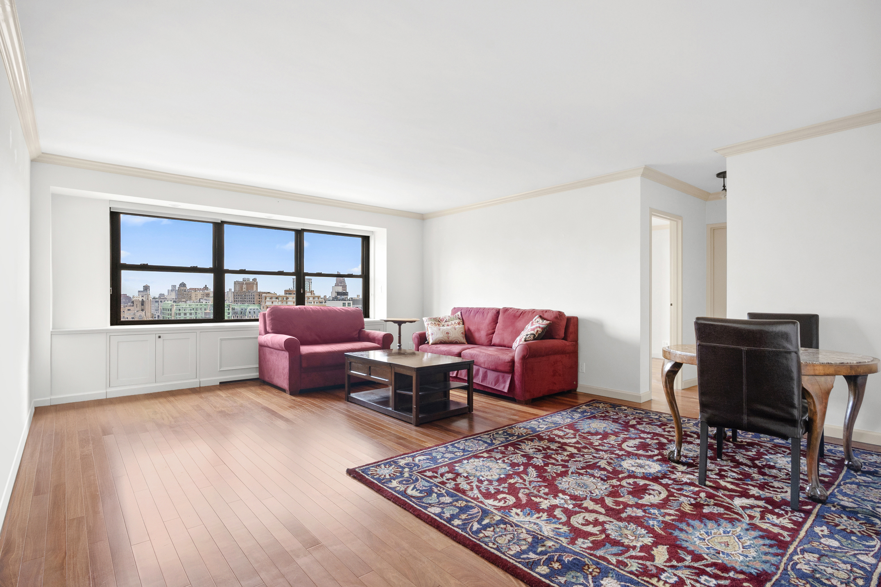 180 West End Avenue, Unit 28S Manhattan, NY 10023 - Photo 3 of 10 a living room with furniture rug and window