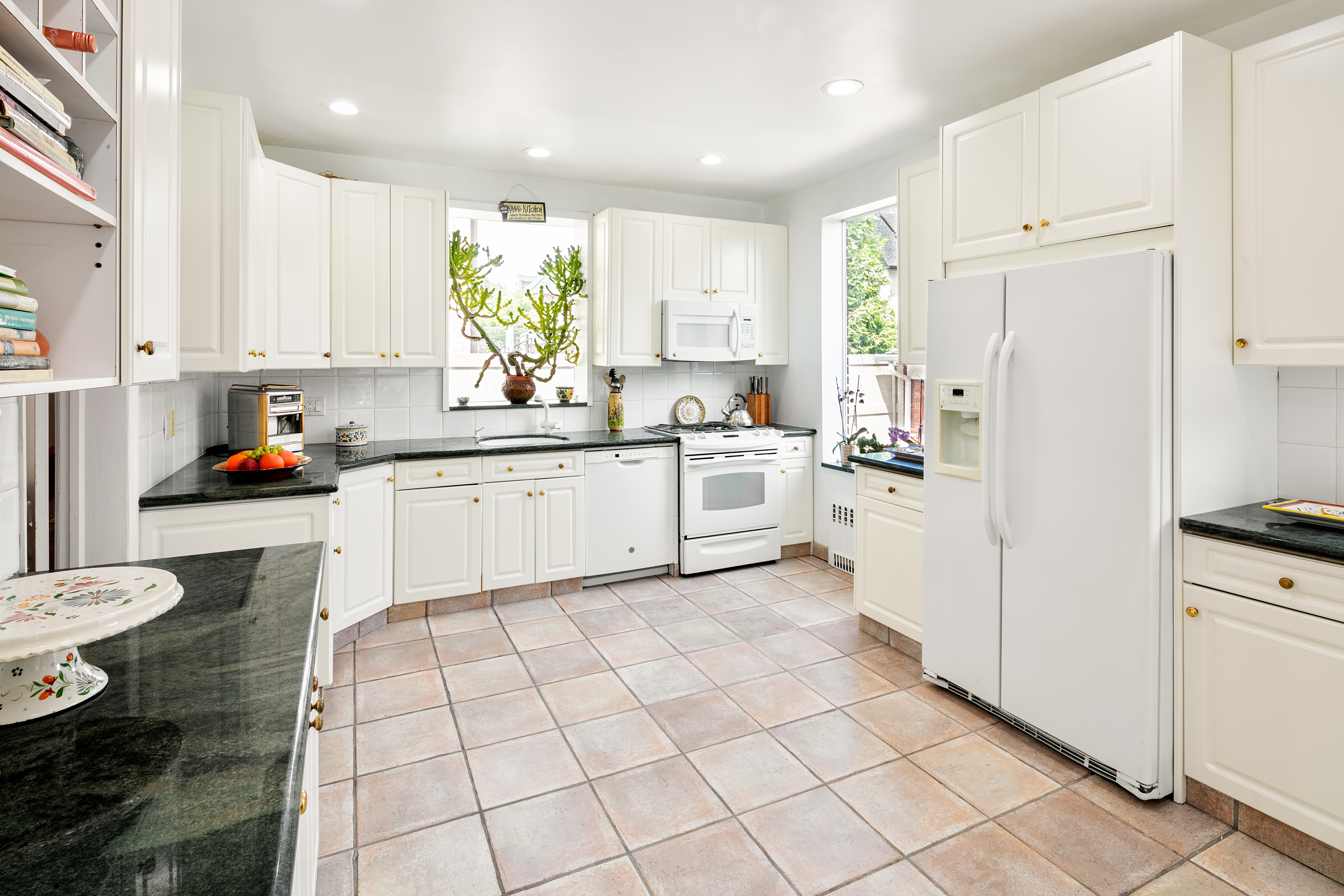91 81st Street Brooklyn, NY 11209 - Photo 9 of 19 a kitchen with white cabinets and white appliances