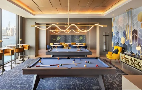 a dining room with furniture a chandelier and wooden floor