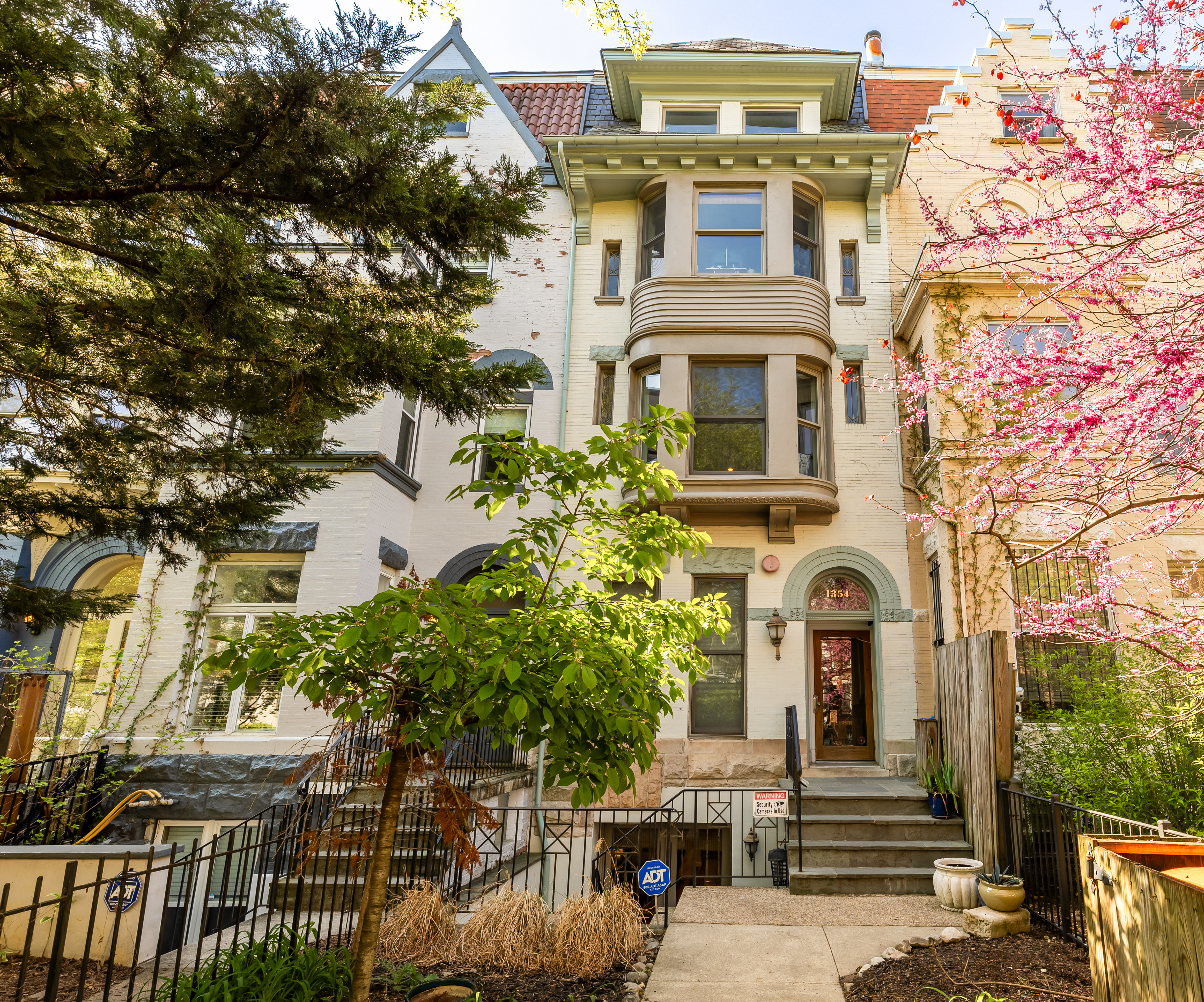 1354 Kenyon Street Northwest, Unit G Washington, DC 20010 - Photo 2 of 35 a front view of a house with a yard
