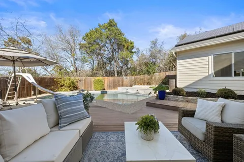 a view of patio with couches and a table and chairs with potted plants