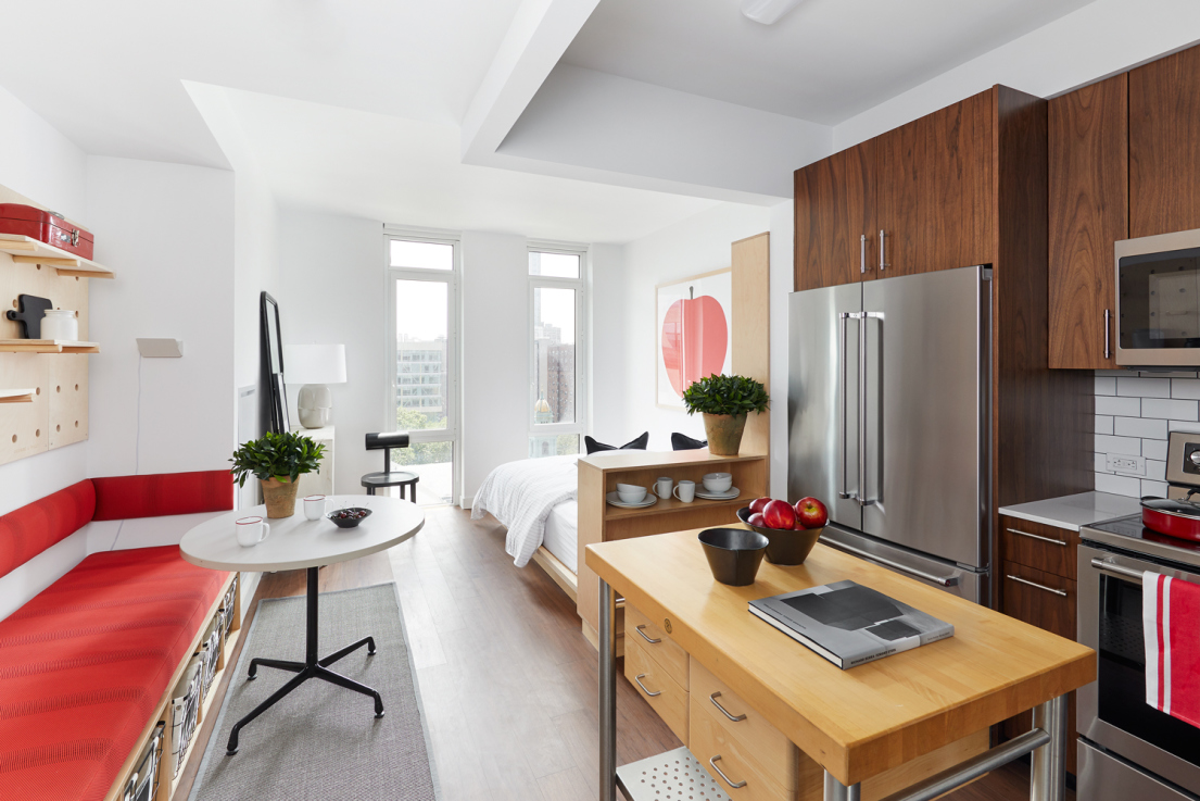120 Nassau Street, Unit 18B Brooklyn, NY 11201 - Photo 1 of 12 a living room with furniture and a dining table with kitchen appliances