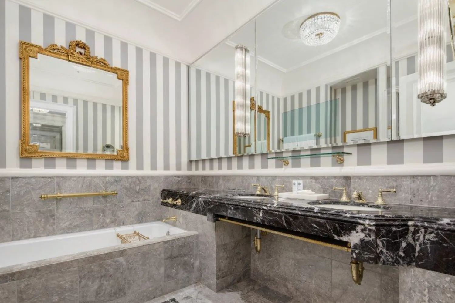 a bathroom with a granite countertop sink a mirror and a bathtub
