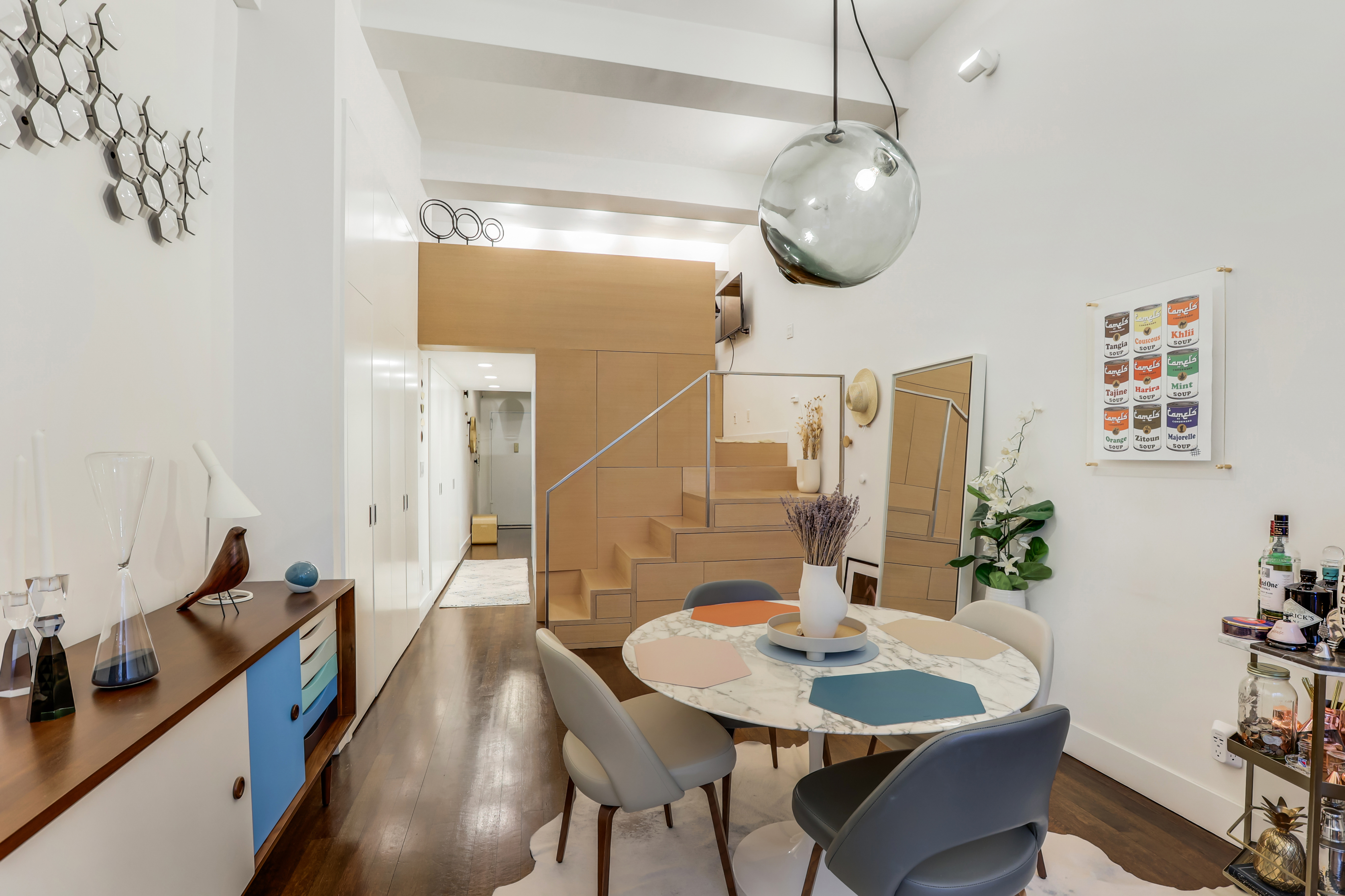 310 East 46th Street, Unit 10S Manhattan, NY 10017 - Photo 5 of 10 a view of a dining room with furniture and wooden floor