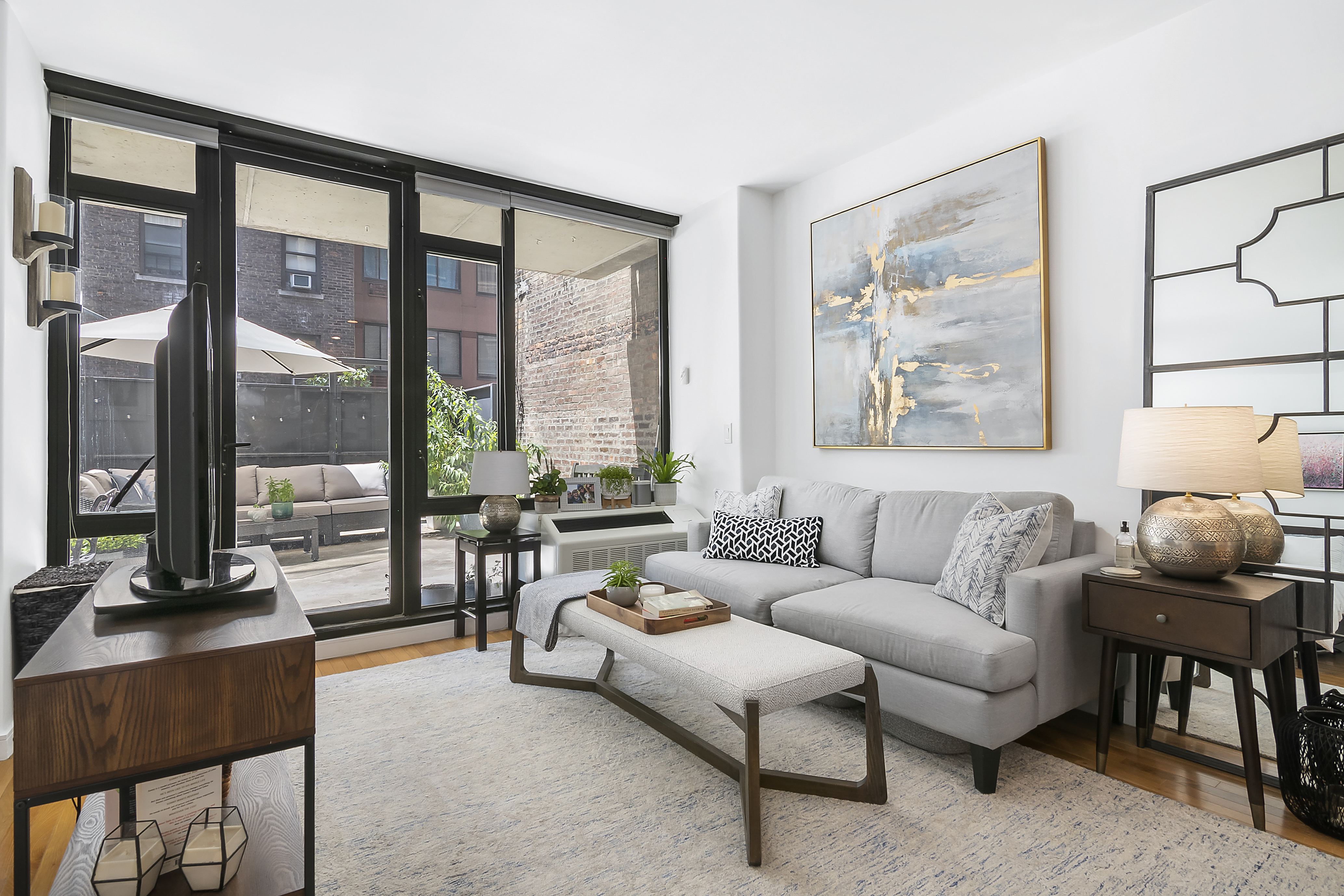 148 East 24th Street, Unit 3F Manhattan, NY 10010 - Photo 3 of 9 a living room with furniture and a floor to ceiling window
