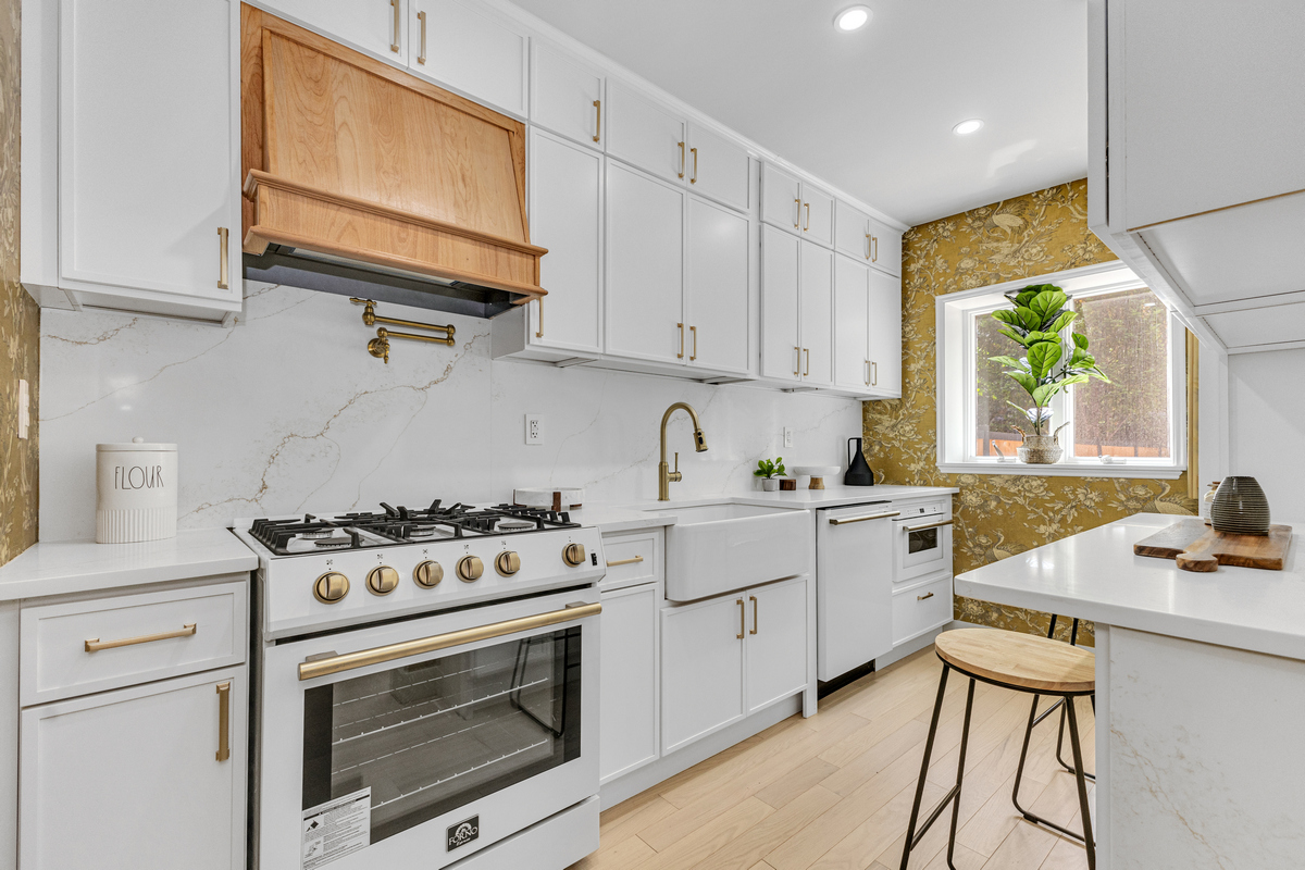 1050 Sterling Place Brooklyn, NY 11213 - Photo 5 of 23 a kitchen with a stove a sink and a microwave