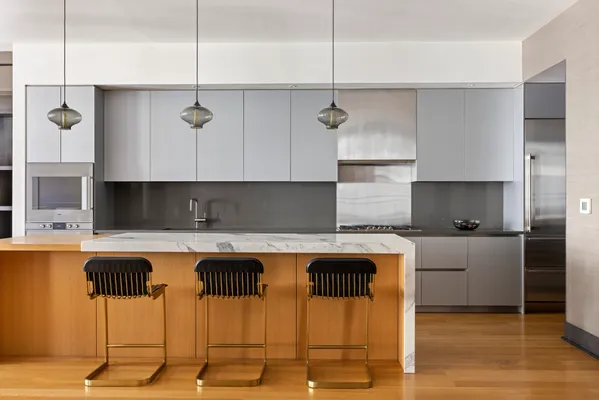 a kitchen with a table chairs stove and cabinets