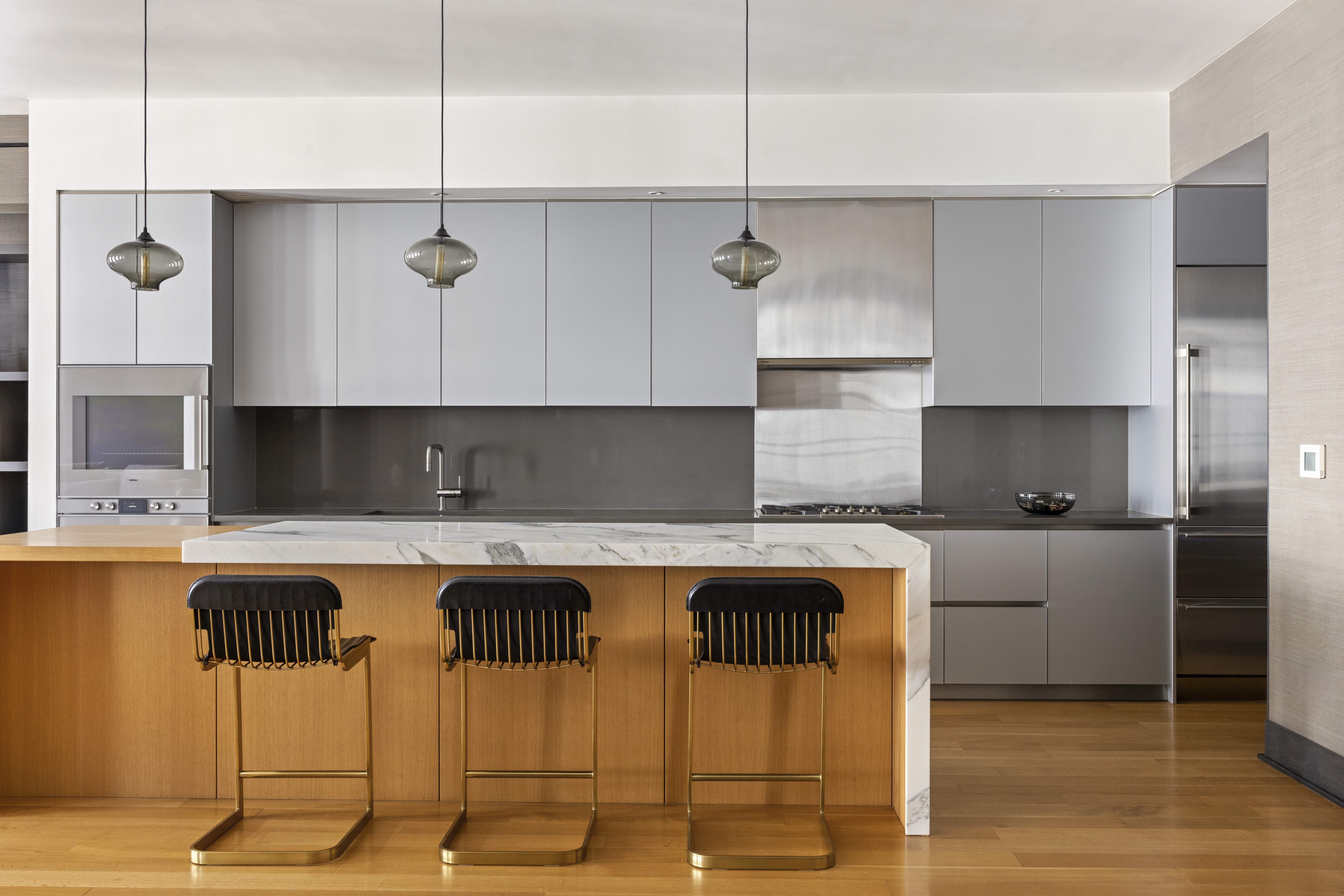 71 Reade Street, Unit 5A Manhattan, NY 10007 - Photo 7 of 27 a kitchen with a table chairs stove and cabinets