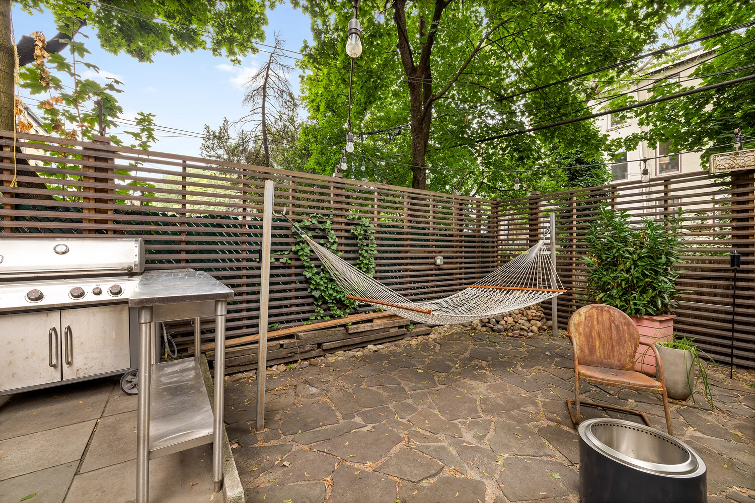a backyard of a house with table and chairs