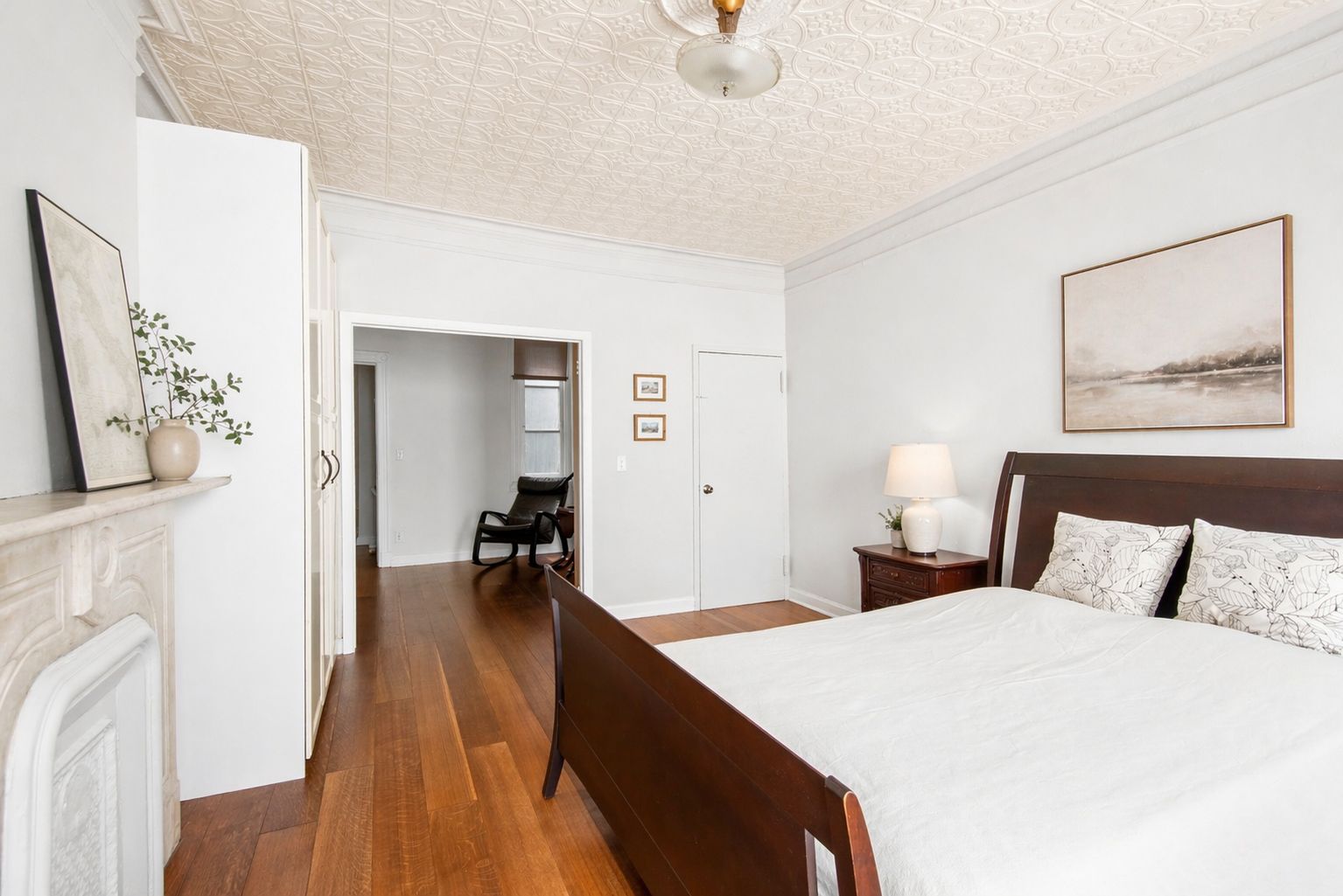 436 East 66th Street, Unit 4E Manhattan, NY 10065 - Photo 10 of 19 a bedroom with a bed and a chandelier