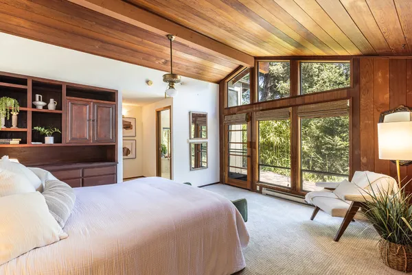 a spacious bedroom with a bed and a large window