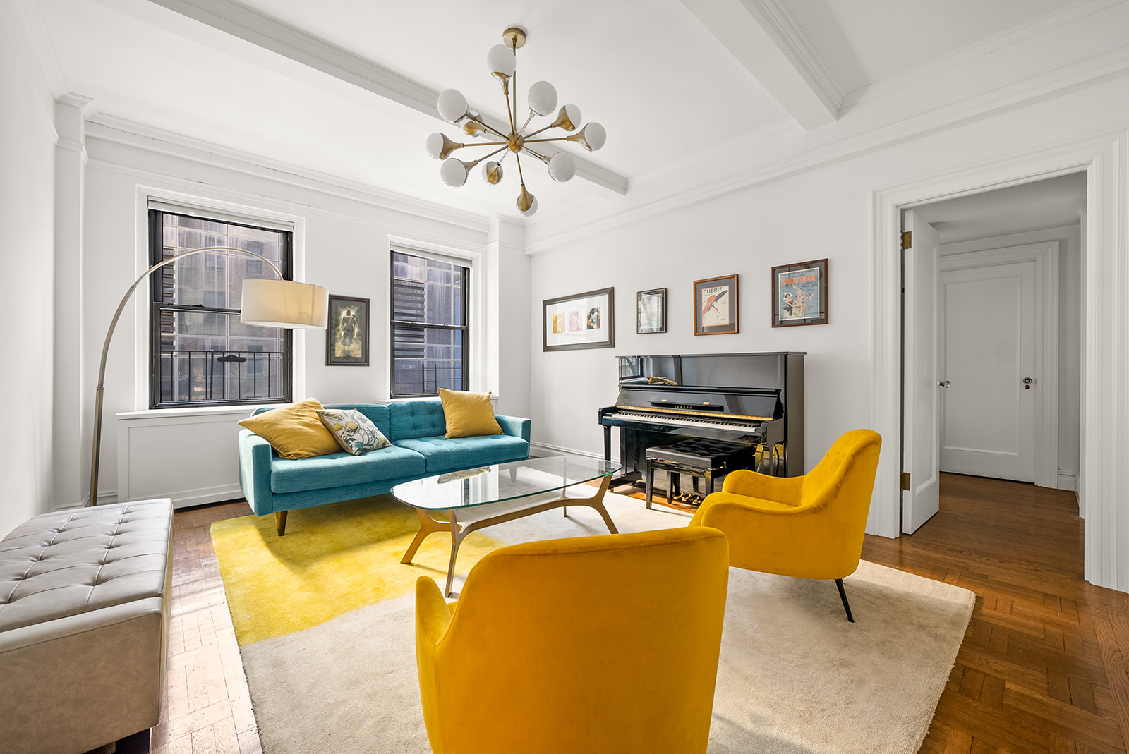 152 West 58th Street, Unit 6CD Manhattan, NY 10019 - Photo 1 of 9 a living room with furniture a flat screen tv and a fireplace
