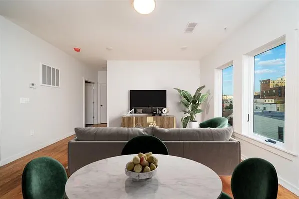 a living room with furniture or couch and a potted plant