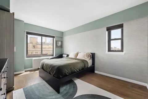 a bed sitting in a bedroom next to a window