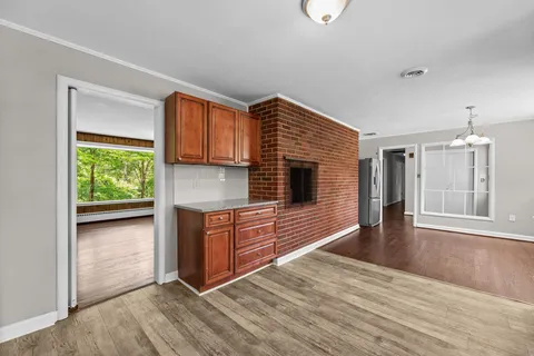a kitchen with granite countertop wooden floors and wide window