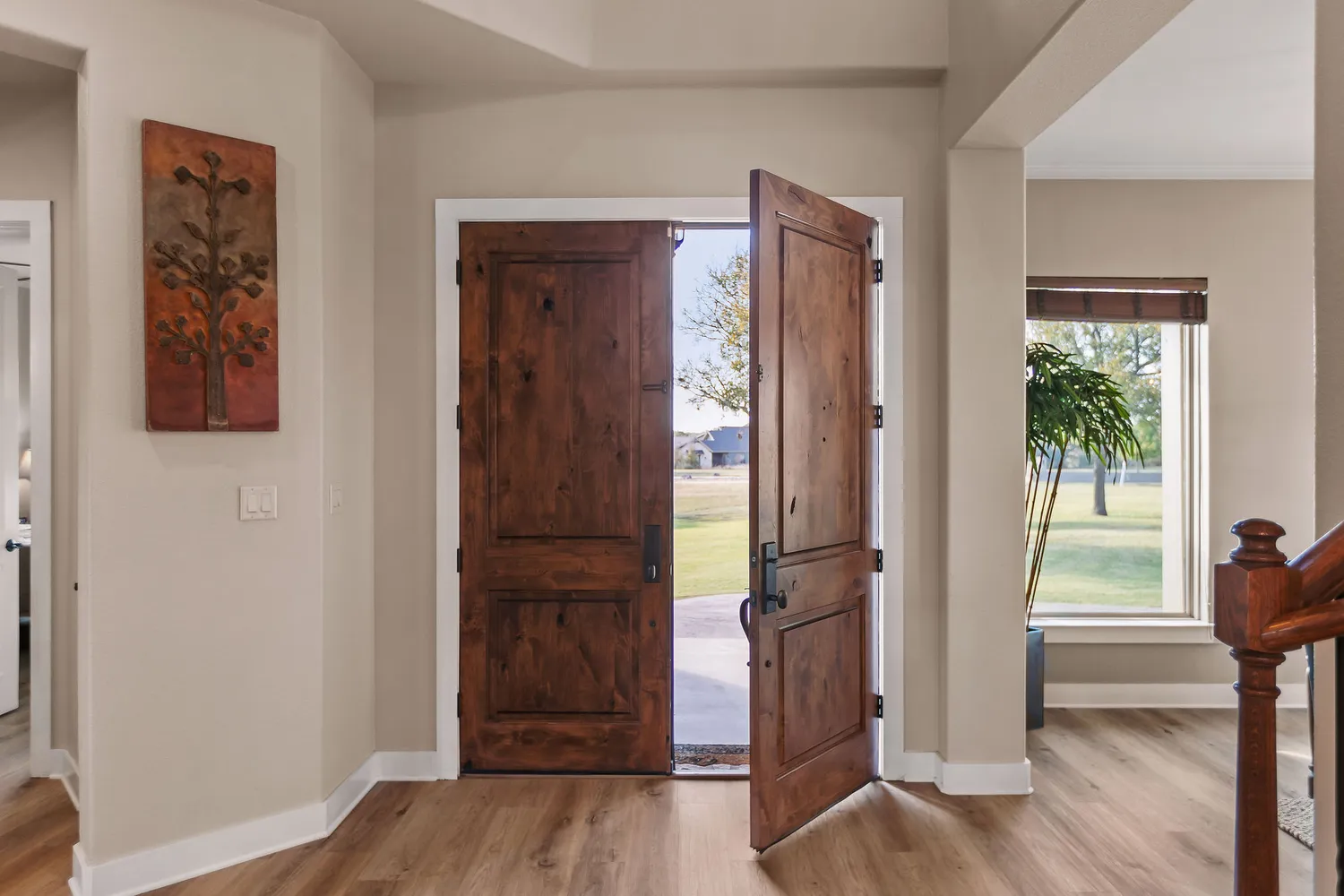 a living room with furniture a flat screen tv and a large window