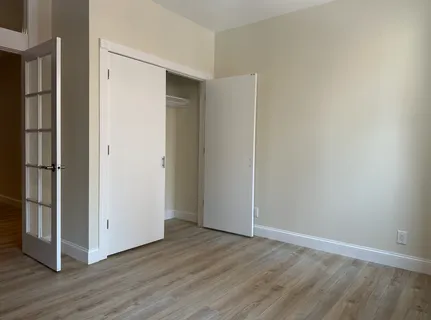 an empty room with wooden floor door