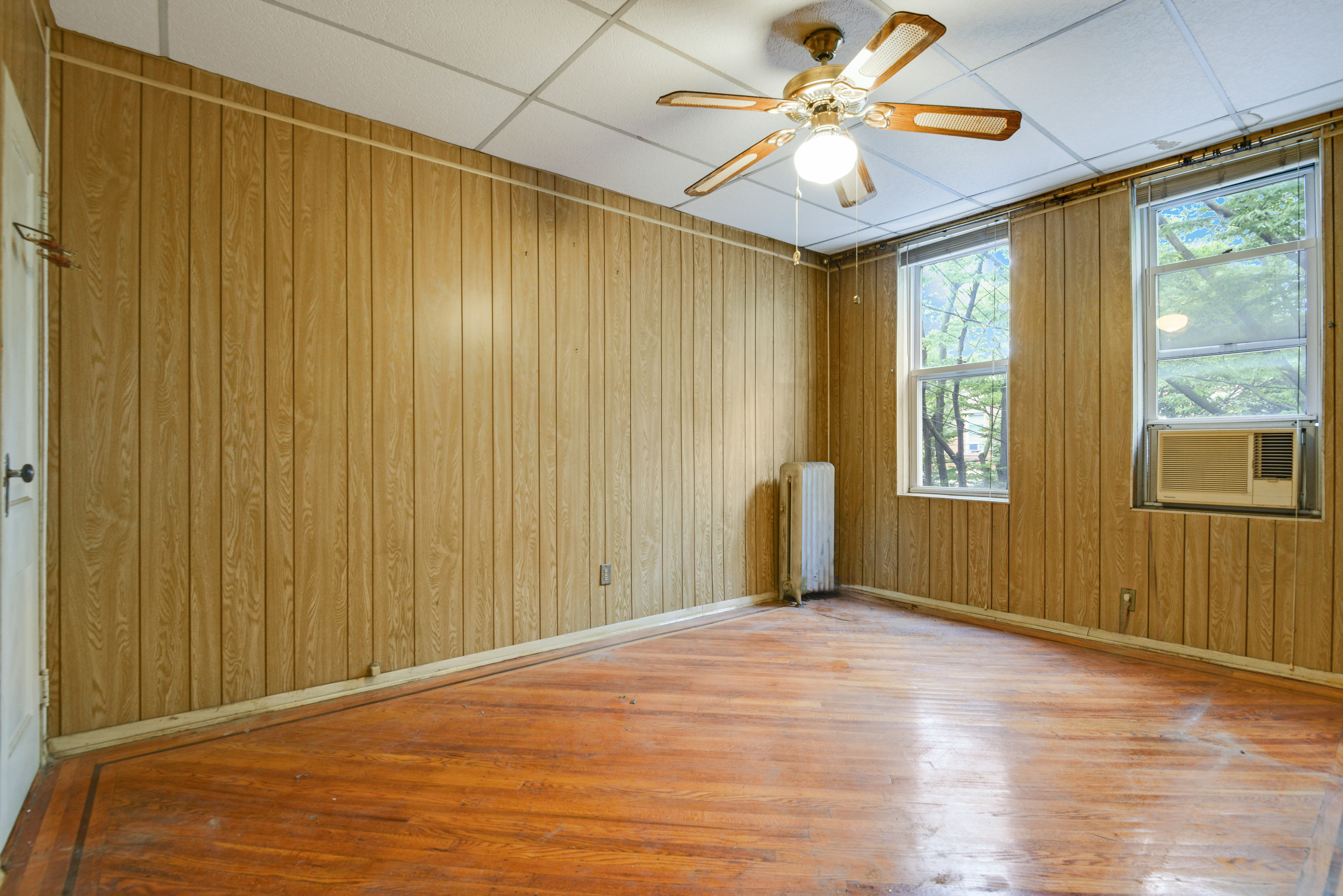 75-36 60th Lane Queens, NY 11385 - Photo 9 of 18 a view of a livingroom with a chandelier fan and wooden floor