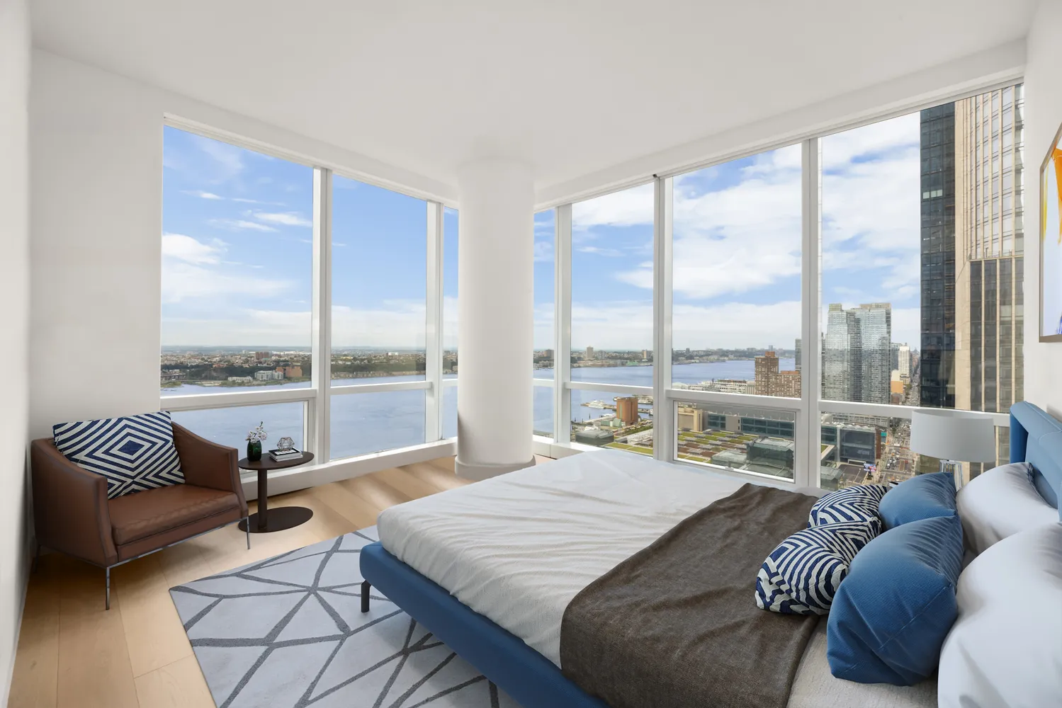 a bedroom with furniture and a large window