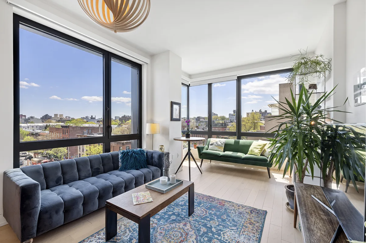 550 Vanderbilt Avenue, Unit 525 Brooklyn, NY 11238 - Photo 3 of 6 a living room with furniture a floor to ceiling window and potted plants
