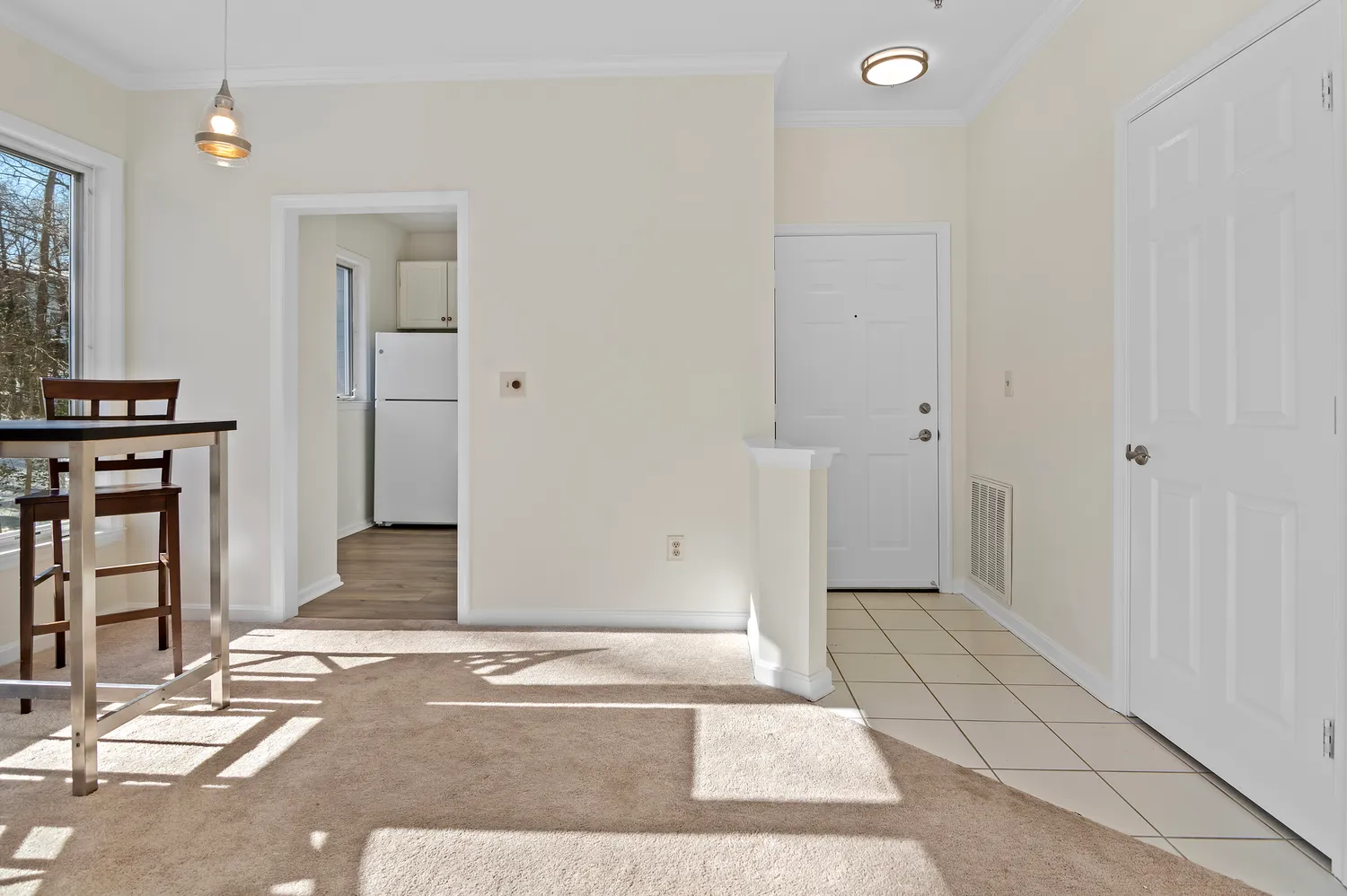 a view of a livingroom with wooden floor and a bathroom