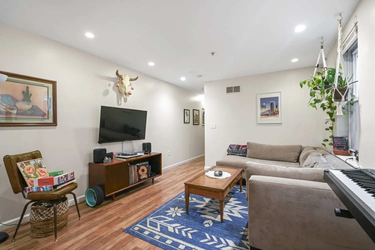 a living room with lots of furniture and a book shelf