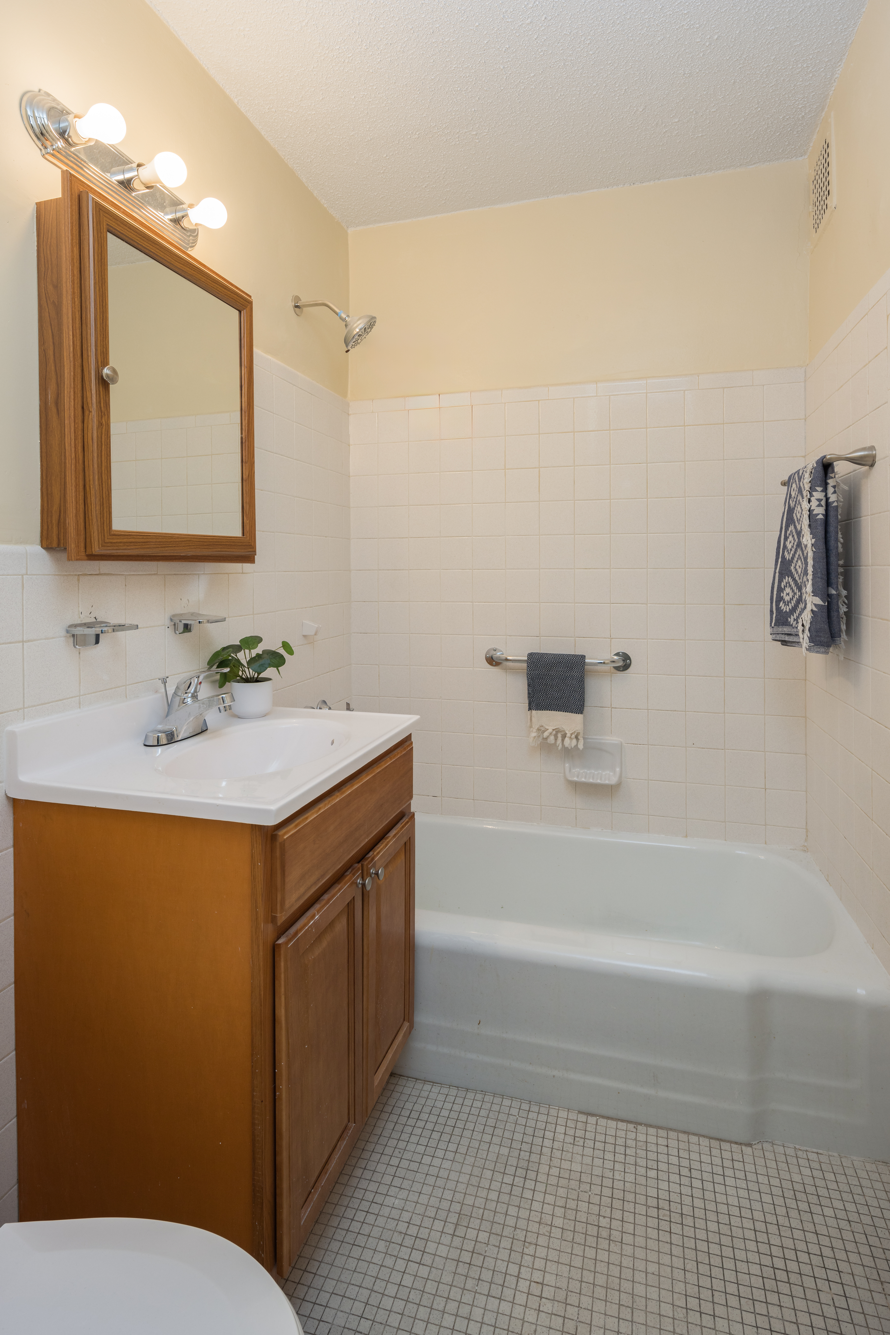 195 Willoughby Avenue, Unit 1610 Brooklyn, NY 11205 - Photo 5 of 7 a bathroom with a sink a toilet and mirror