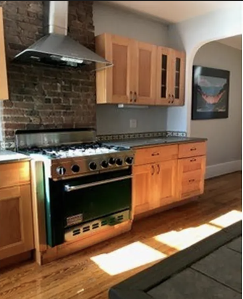 a kitchen with granite countertop a stove and a microwave